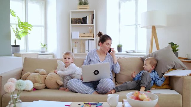 Mother with small children working in home office, quarantine concept.