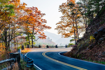 A curvy road in the Great Smoky Mountains of North Carolina on a sunny fall afternoon