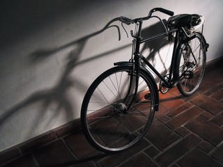 Fototapeta na wymiar High Angle View Of Bicycle On Sidewalk Against Wall