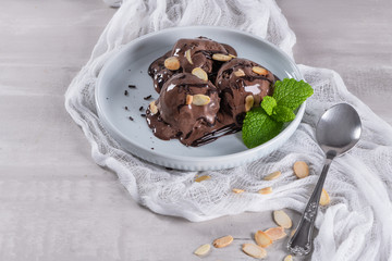 Delicious chocolate ice cream for dessert on plate with mint leaf