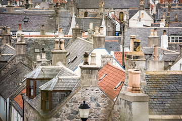 Old croft houses in Cullen, fishing village on Moray Firth, Scotland. Cullen Viaduct in the background, old roofs and chimneys © lukasz_kochanek