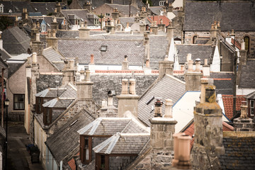 Old croft houses in Cullen, fishing village on Moray Firth, Scotland. Cullen Viaduct in the background, old roofs and chimneys © lukasz_kochanek