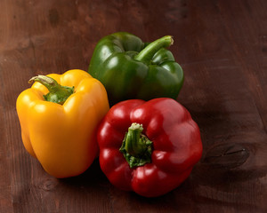 yellow,red,green, sweet bell pepper on wooden background