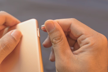 Employees are putting nano SIM cards in the store for customers to buy,Man's hand,In the sim card...
