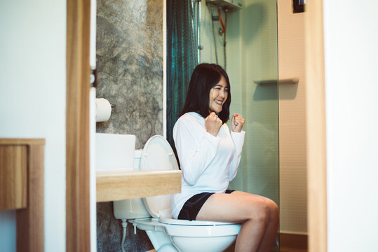 Asian woman sufferring with Hemorrhoids or constipation in toilet,Female need to use the toilet in the morning