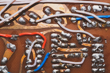 Handmade circuit board with connections and traces. colorful wires