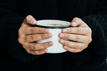 woman holding a cup of coffee.