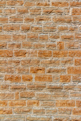 Old 19th century tan color limestone wall texture with rough natural stone blocks and tuckpointing mortar joints