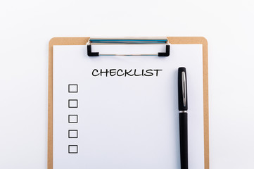 "CHECKLIST" concept. Note pad and white paper on white background, copy space