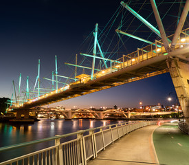 Kurilpa bridge Brisbane river city and bike transport path at night with William jolly bridge background - obrazy, fototapety, plakaty