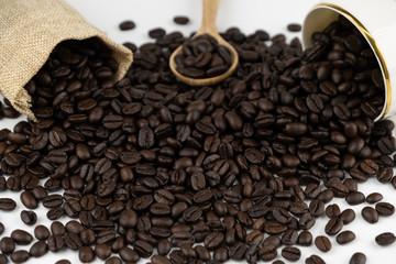 coffee cup wooden spoon and bag with roasted beans spread on white background