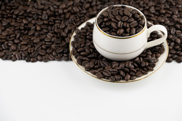 Coffee cup with roasted beans on white background, copy space text