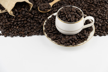 Coffee cup with roasted beans on white background, copy space text