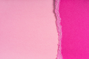 Pieces of torn ragged purple paper edges on pink background. Ripped cracked paper edge isolated...