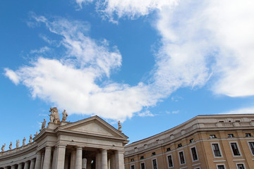 Naklejka premium A group of Saint Statues on the colonnades of St Peter's Square with blue sky and clouds in Vatican City, Rome, Italy