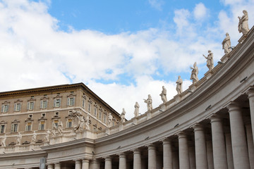 A group of Saint Statues on the colonnades of St Peter's Square with blue sky and clouds in Vatican City, Rome, Italy