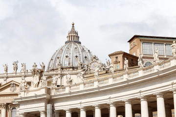 A group of Saint Statues on the colonnades of St Peter's Square with dome in Vatican City, Rome,...