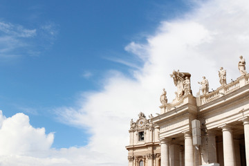 A group of Saint Statues on the colonnades of St Peter's Square with blue sky and clouds in Vatican City, Rome, Italy
