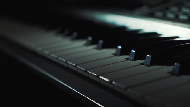 Close-up of piano keys frontal view.  Piano keyboard background with selective focus. Music, tune, musician. Profession and tools concept