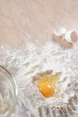 Kitchen table with ingredients for cooking baking. Copy space. Cooking concept. Eggs, flour on background. Dough ingredients.