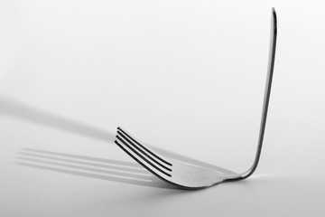 Fork and the shadow on white background