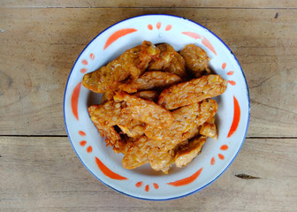 Fried tempeh on a plate. Vegan snack.