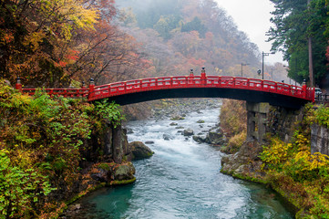 Shinkyo Bridge in rainy day at Nikko, Japan. The historical red bridge over the Daiwa River.