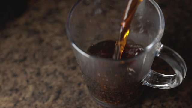 A Pouring Coffee in a Clear Transparent Mug-Close up Shot
