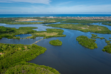 Fototapeta na wymiar Canal de Santa Cruz, south of the island of Itamaraca, near Recife, Pernambuco, Brazil on March 1, 2014. Forests, mangroves and coconut trees between the river, forming small islands. Aerial view