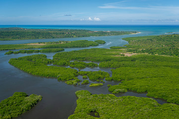 Fototapeta na wymiar Santa Cruz channel, south of the island of Itamaraca, near Recife, Pernambuco, Brazil on March 1, 2014. Forests, mangroves and coconut trees between the river, forming small islands. Aerial view