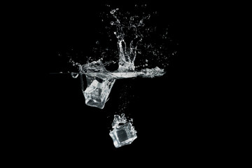 ice cubes drop to water, isolated with black background