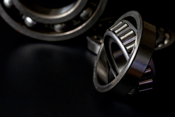 Closeup of Tapered roller bearing with copy space for your text on black background. Spare part of mechanical .
