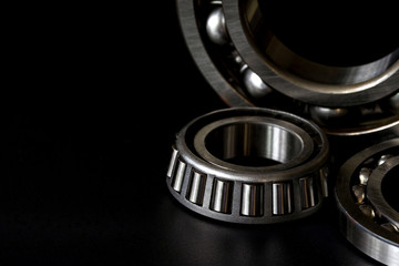 Closeup of Tapered roller bearing with copy space for your text on black background. Spare part of mechanical .