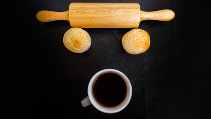 Black coffee and bakery in black background. Healthy breakfast. coffee lover