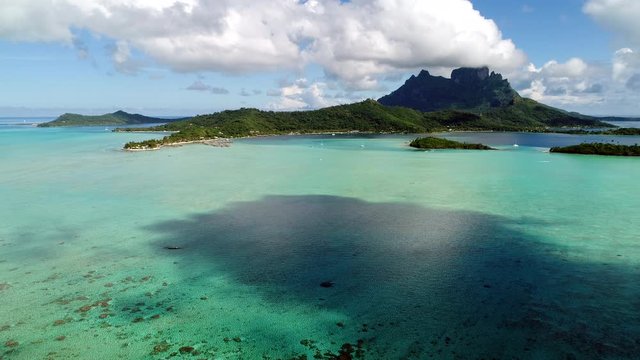 Gorgeous summer scenic tropical island paradise drone landscape of Bora Bora on a sunny summer beautiful day. Vacation tourist trip near the coast and island beaches.