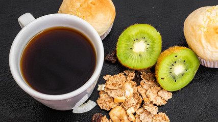 Black coffee and bakery in black background. Healthy breakfast in beautiful set up with lavender fruits.