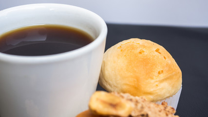 Black coffee and bakery in black background. Healthy breakfast. coffee lover