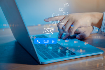 Contact us or Customer support hotline people connect. Businessman using a laptop computer with the (email, call phone, mail) icons.