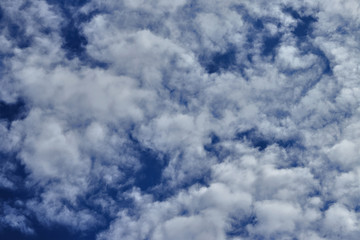 White fluffy clouds in blue sky