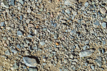 Sand texture with stones of different sizes and colors