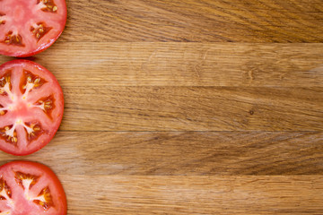 Red tomato slices on chopping board. Copy space for inscription. use for title, header, content, menu background.
