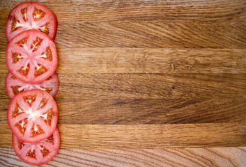Red tomato slices on chopping board. Copy space for inscription. use for title, header, content, menu background.