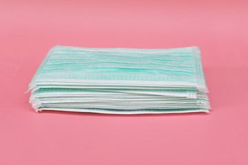 Heap Medical face mask, Medical protective mask on pink background. Disposable surgical face mask cover the mouth and nose. protect Healthcare and medical concept