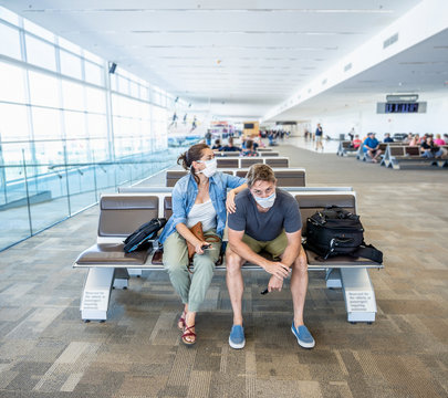 Couple with mask stuck in airport no able to return home country due to COVID-19 border closures.