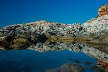 Fototapeta premium Huge rocks reflected in the water