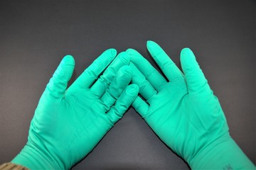 Human hands wearing sterile surgical gloves isolated on black background.Protect medical professionals and patients from invasive particles.Personal protective equipment,PPE.