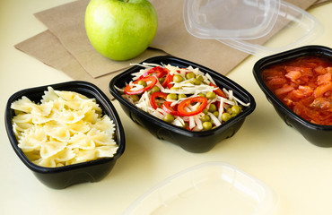 Healthy food delivery in plastic containers on a light background