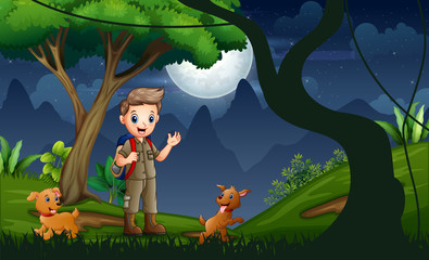 Scout boy with dogs hiking at night