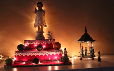 Sculpture And Illuminated Decorations On Table During Christmas At Home