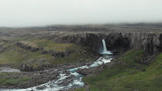 Aerial view on Folaldafoss Waterfall ,  in the East Fjords. On an overcast day